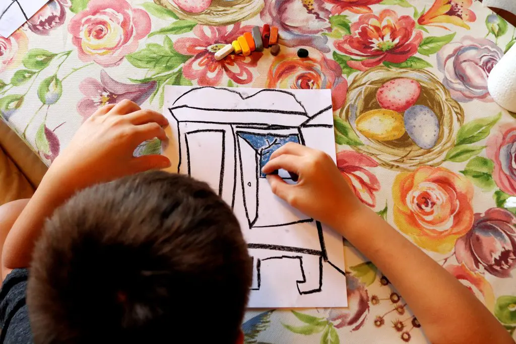 Boy Drawing A Colourful Chalk Picture Of His Family High-Res Stock